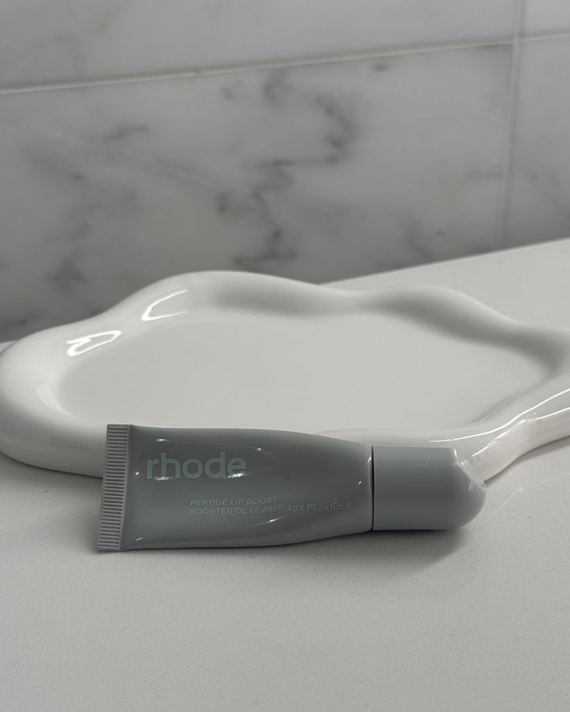 rhode Peptide Lip Mask tube on a marble background