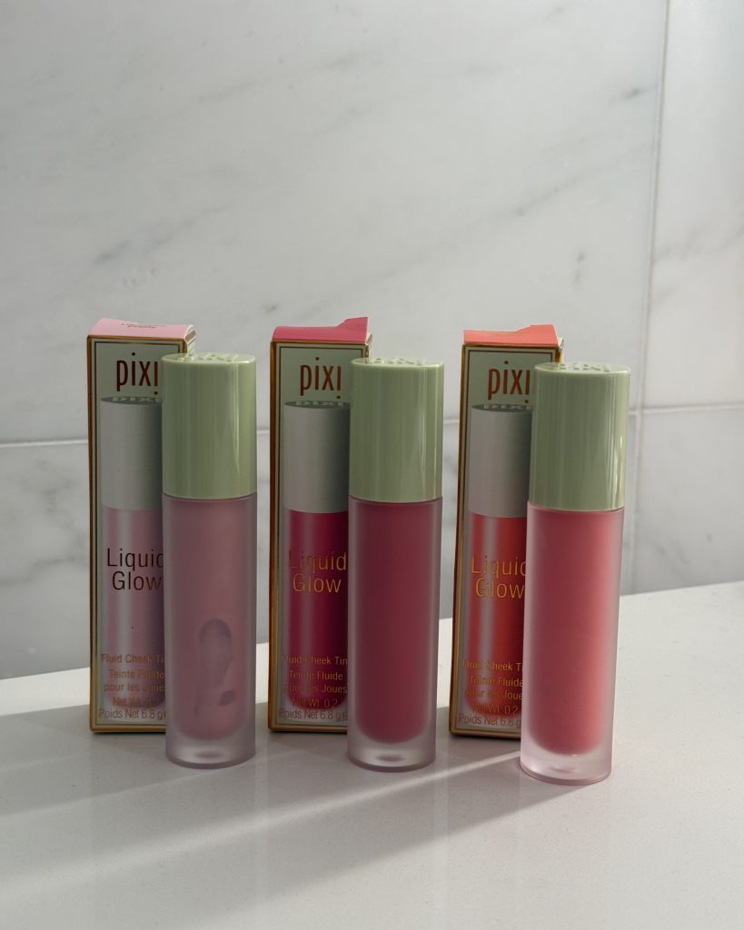 Three Pixi On-the-Glow Blush sticks displayed on marble