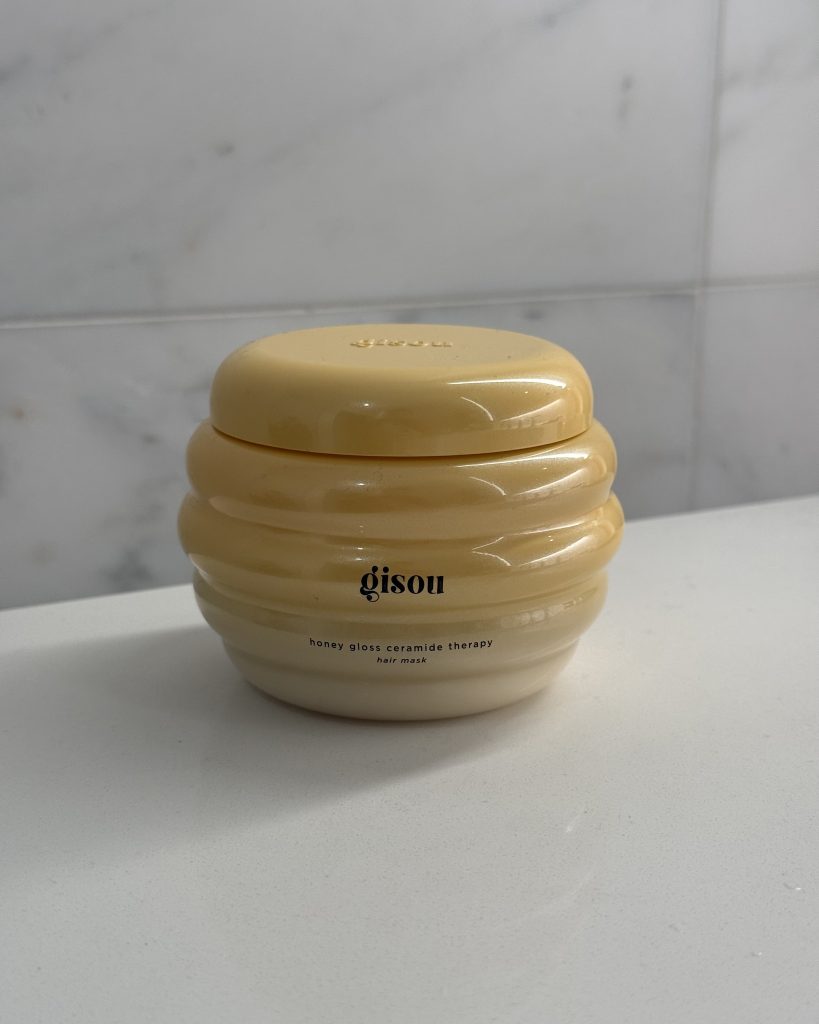 Gisou Honey Gloss Ceramide Therapy Hair Mask jar on marble