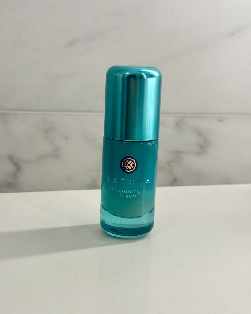 TATCHA The Longevity Serum bottle on a marble background